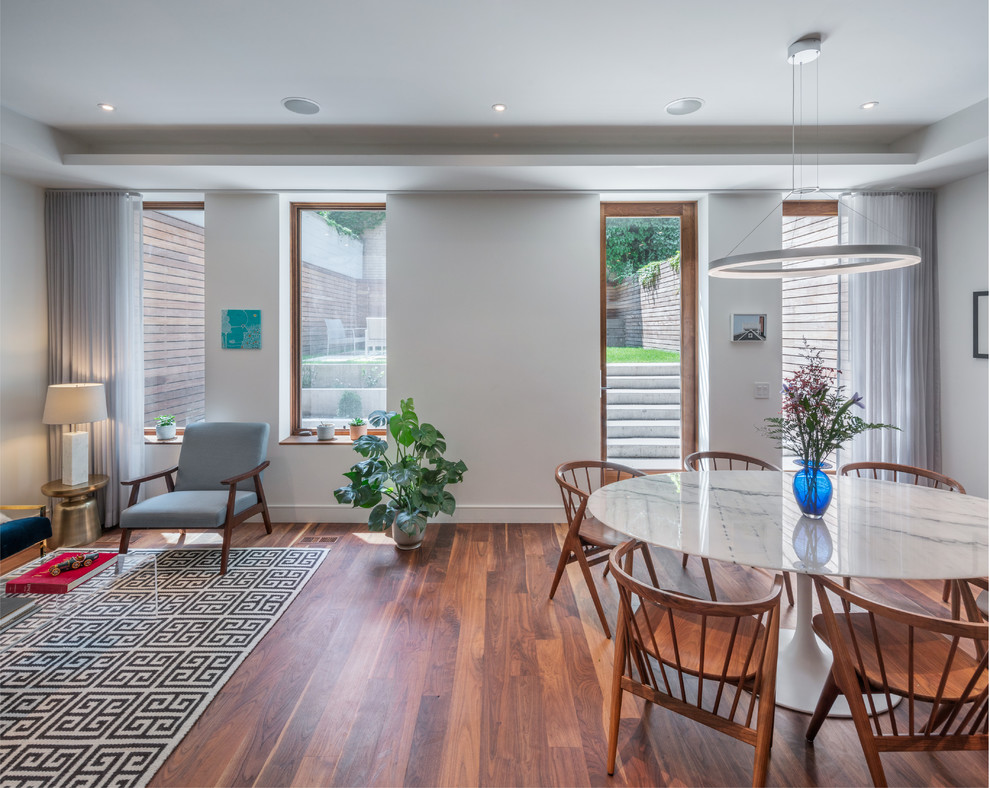 Dining room - transitional dark wood floor and brown floor dining room idea in New York with white walls
