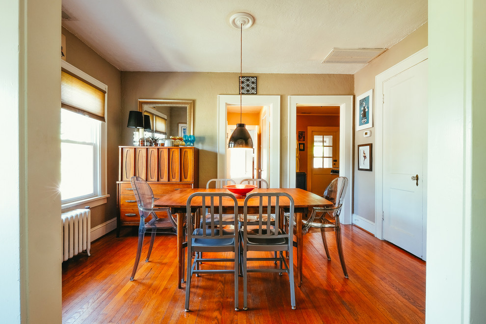Foto di una piccola sala da pranzo aperta verso la cucina minimalista con pareti beige e pavimento in legno massello medio