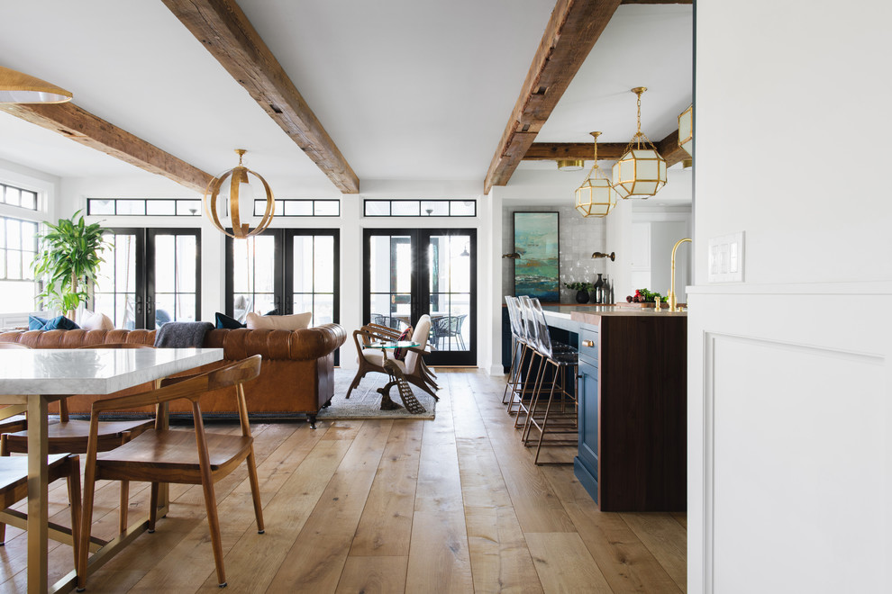 Inspiration for a mid-sized transitional medium tone wood floor and brown floor kitchen/dining room combo remodel in Grand Rapids with white walls