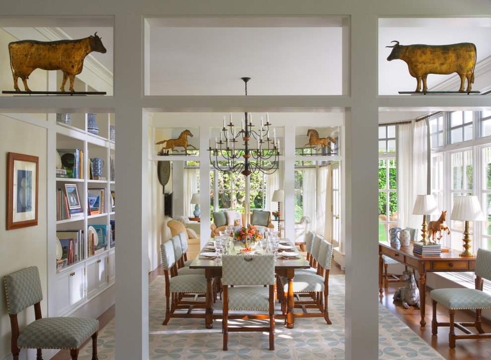Country enclosed dining room in New York with white walls and feature lighting.