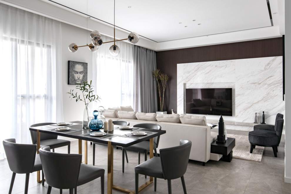 Inspiration pour une salle à manger ouverte sur le salon design en bois avec un mur blanc et un sol gris.