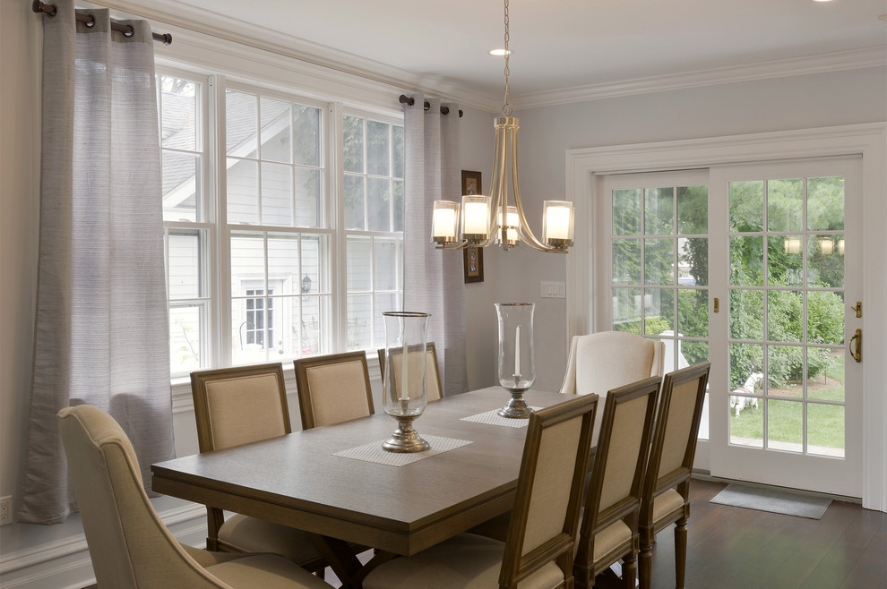 This is an example of a medium sized traditional open plan dining room in New York with grey walls, dark hardwood flooring, no fireplace and brown floors.