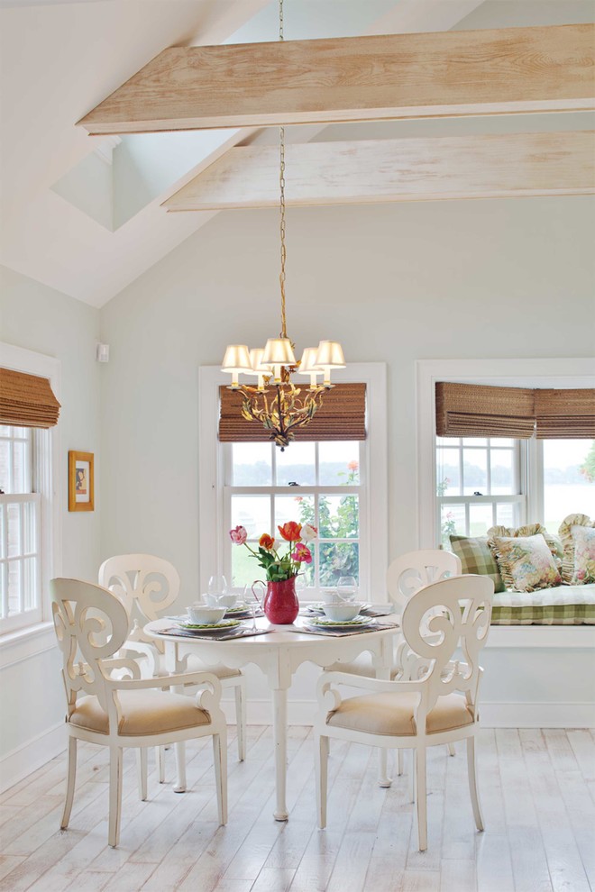 This is an example of a traditional dining room in Baltimore with grey walls and light hardwood flooring.