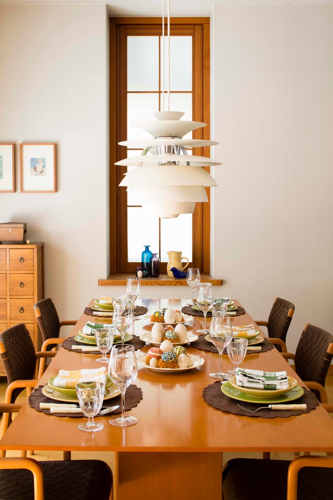 Trendy dining room photo in Tokyo with white walls