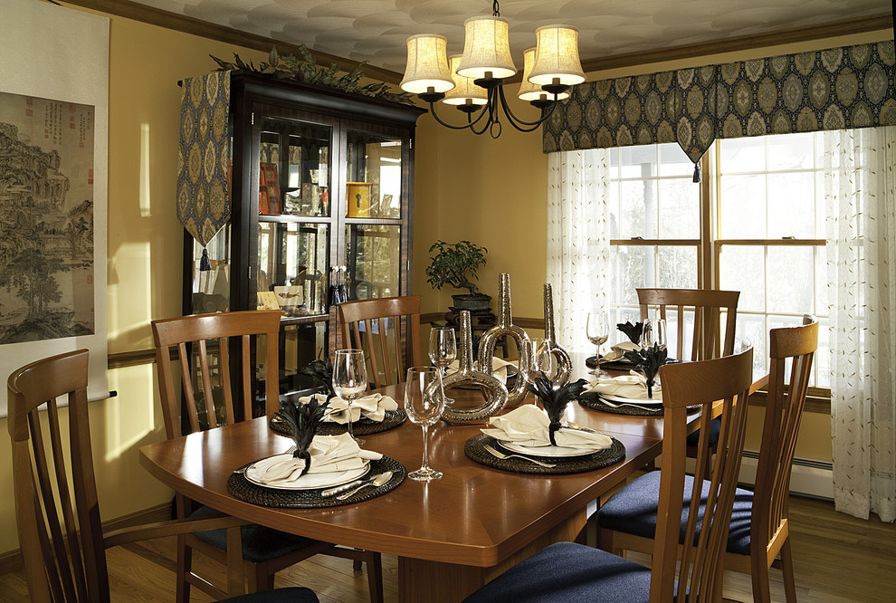 Inspiration for a contemporary dining room in Boston with yellow walls.