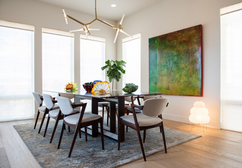 Contemporary enclosed dining room in Denver with white walls, medium hardwood flooring, no fireplace and brown floors.