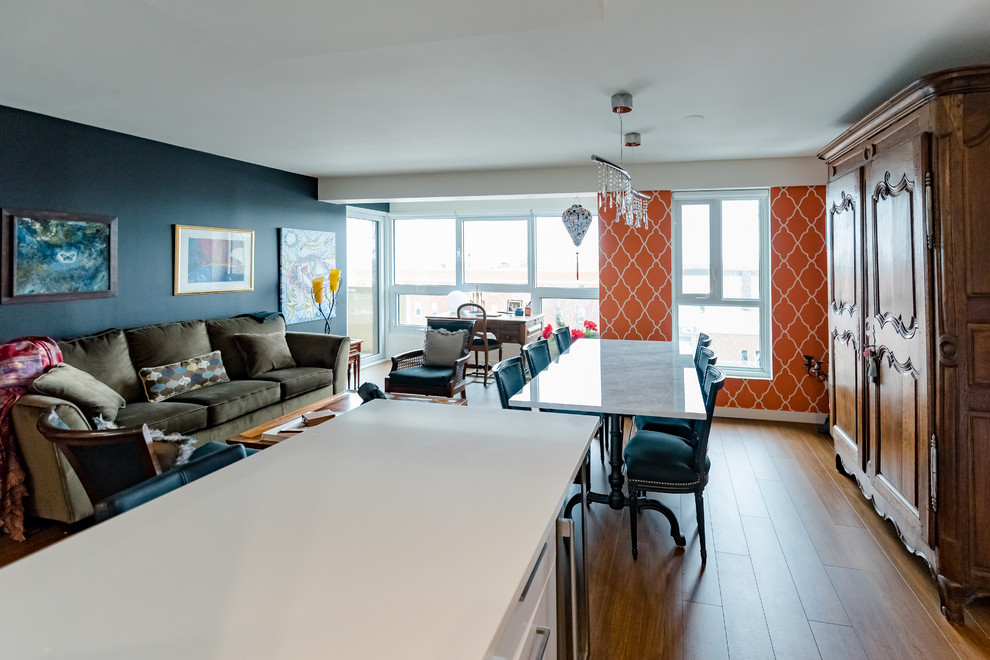 Стильный дизайн: гостиная-столовая среднего размера в стиле фьюжн с темным паркетным полом, коричневым полом и оранжевыми стенами без камина - последний тренд