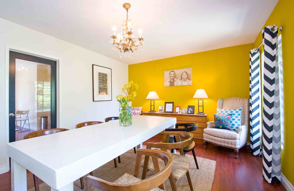Eclectic dining room in Los Angeles with yellow walls.