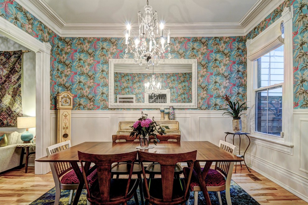 Example of a mid-sized eclectic light wood floor and brown floor enclosed dining room design in Toronto with multicolored walls and no fireplace