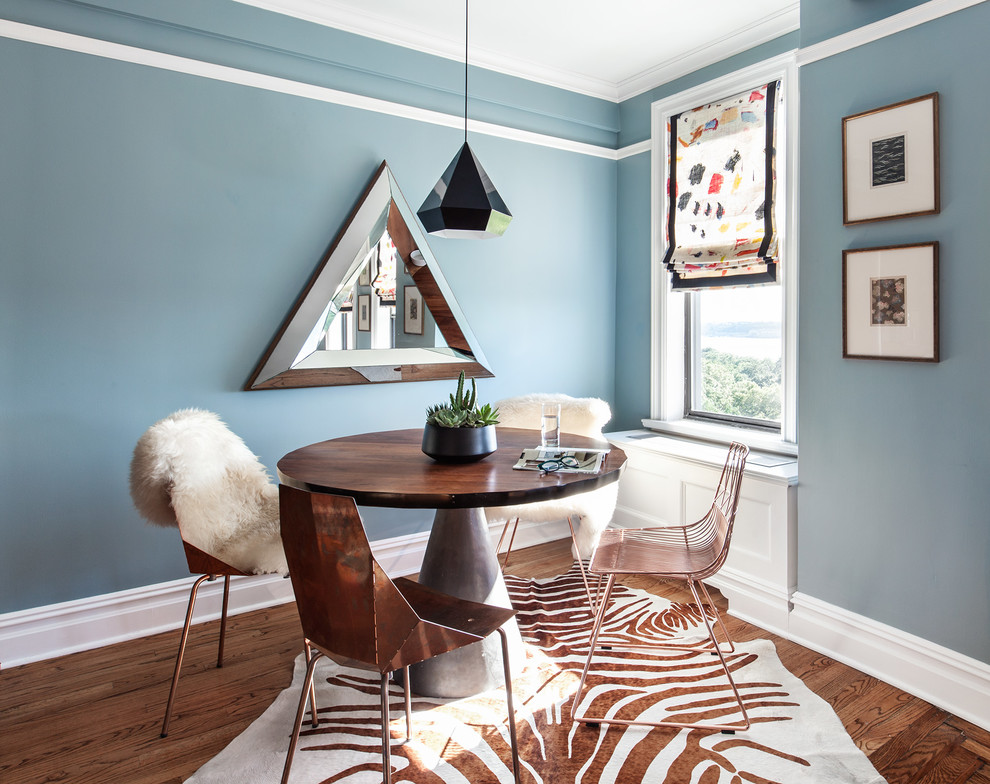 Design ideas for a bohemian dining room in New York with blue walls and dark hardwood flooring.