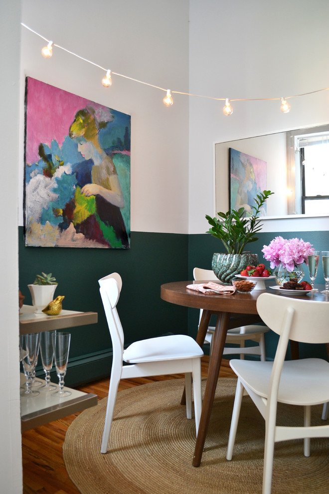 Imagen de comedor bohemio con paredes verdes y suelo de madera en tonos medios