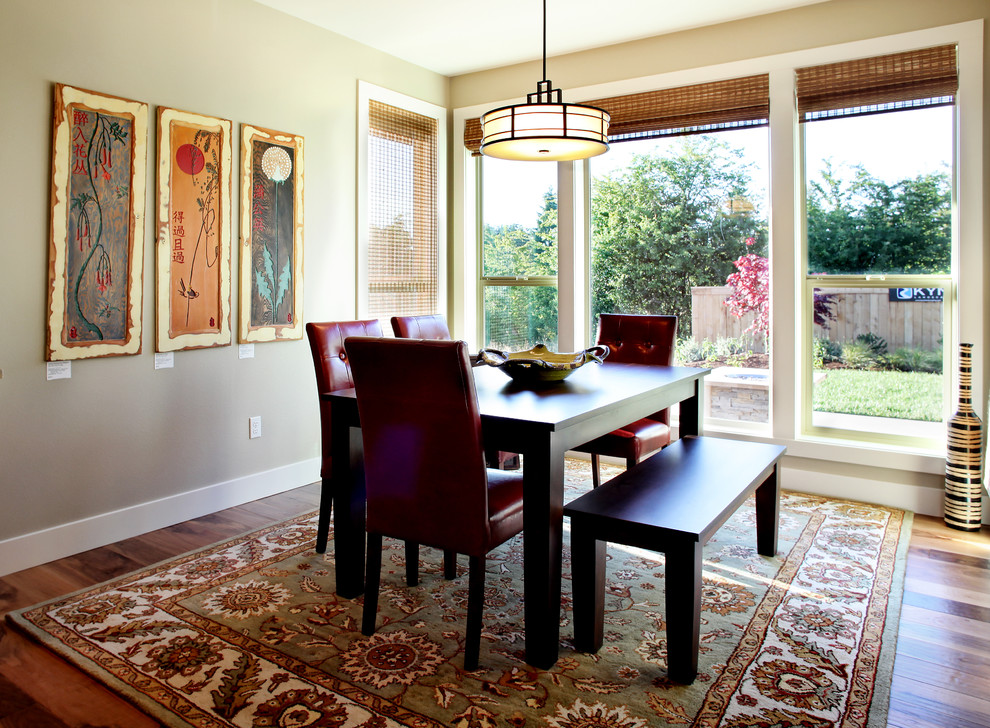 Example of a trendy dark wood floor dining room design in Portland with beige walls