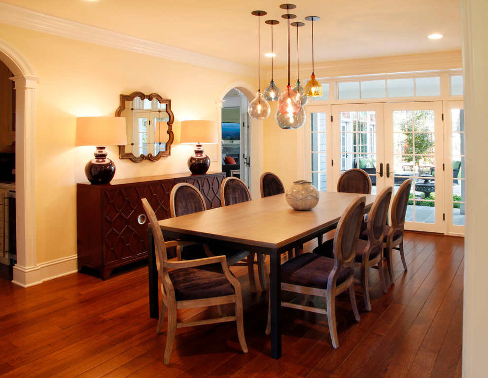 Medium sized contemporary kitchen/dining room in San Francisco with yellow walls and medium hardwood flooring.
