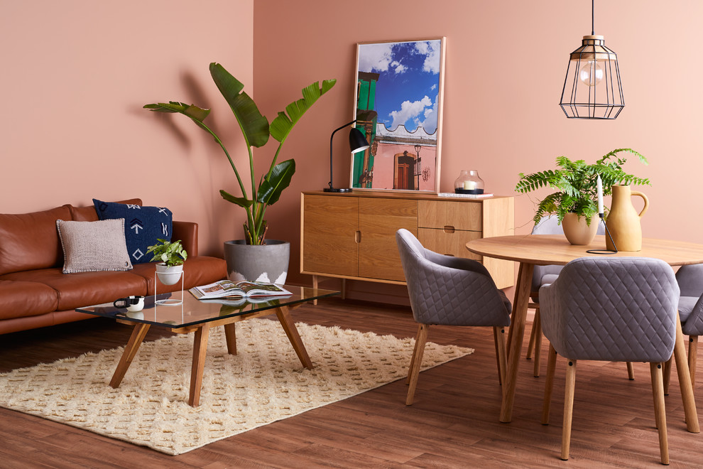 На фото: маленькая гостиная-столовая в современном стиле с розовыми стенами, полом из винила и бежевым полом для на участке и в саду