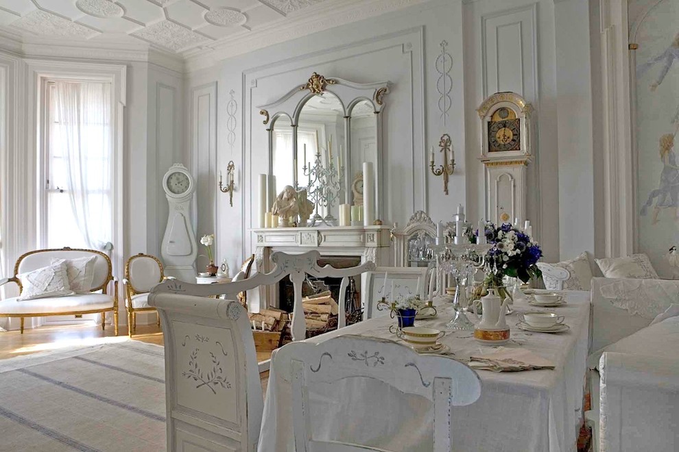Dining room - shabby-chic style dining room idea in Other with a standard fireplace