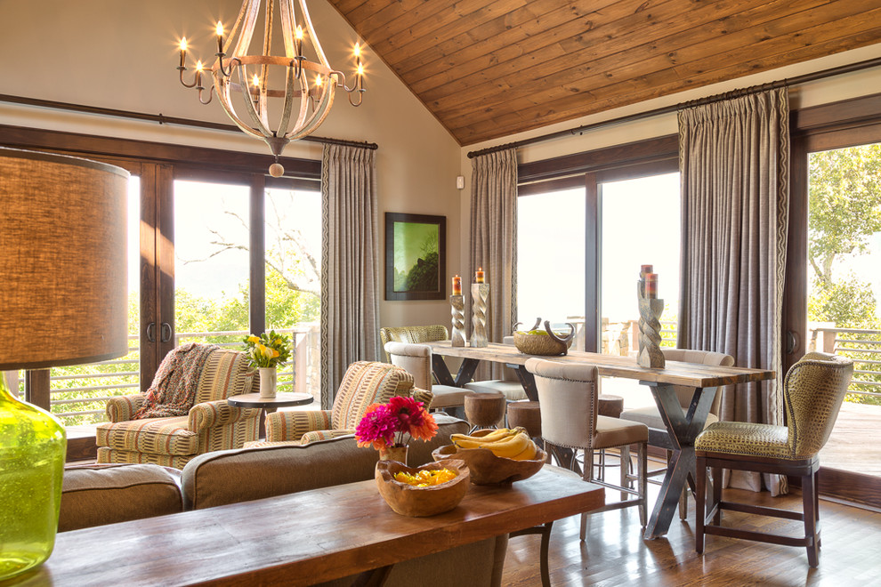 Idée de décoration pour une salle à manger ouverte sur le salon chalet de taille moyenne avec un mur beige et un sol en bois brun.