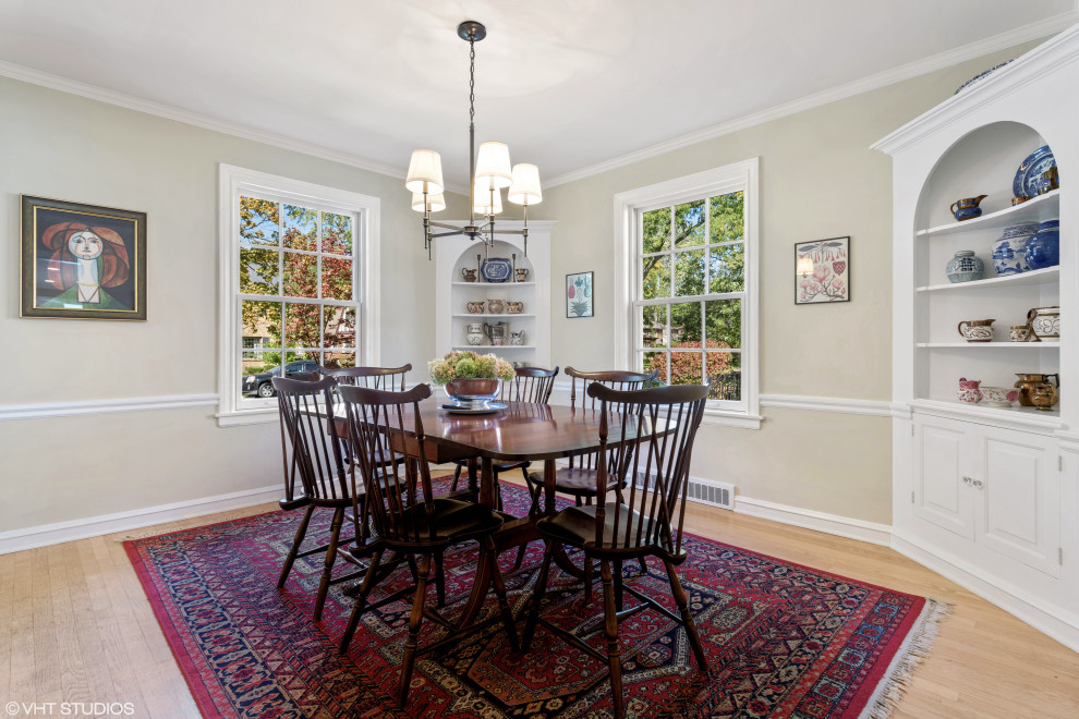 Inspiration for a mid-sized timeless light wood floor enclosed dining room remodel in Chicago with beige walls