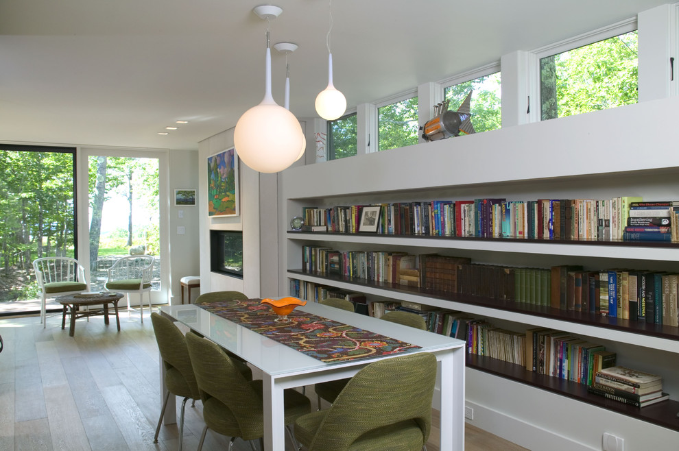 This is an example of a modern dining room in Boston with white walls.