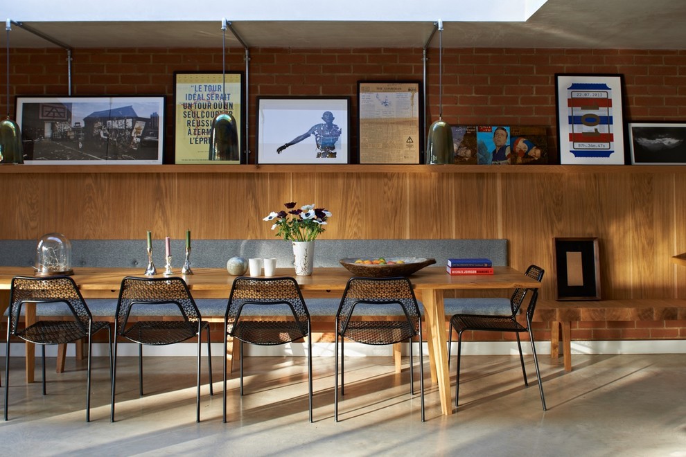 Photo of a medium sized contemporary dining room in London with concrete flooring and grey floors.