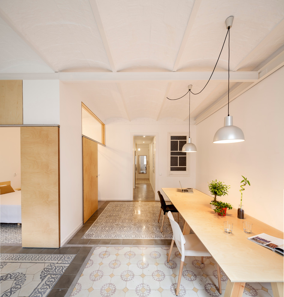 Large eclectic enclosed dining room in Barcelona with white walls, ceramic flooring and no fireplace.