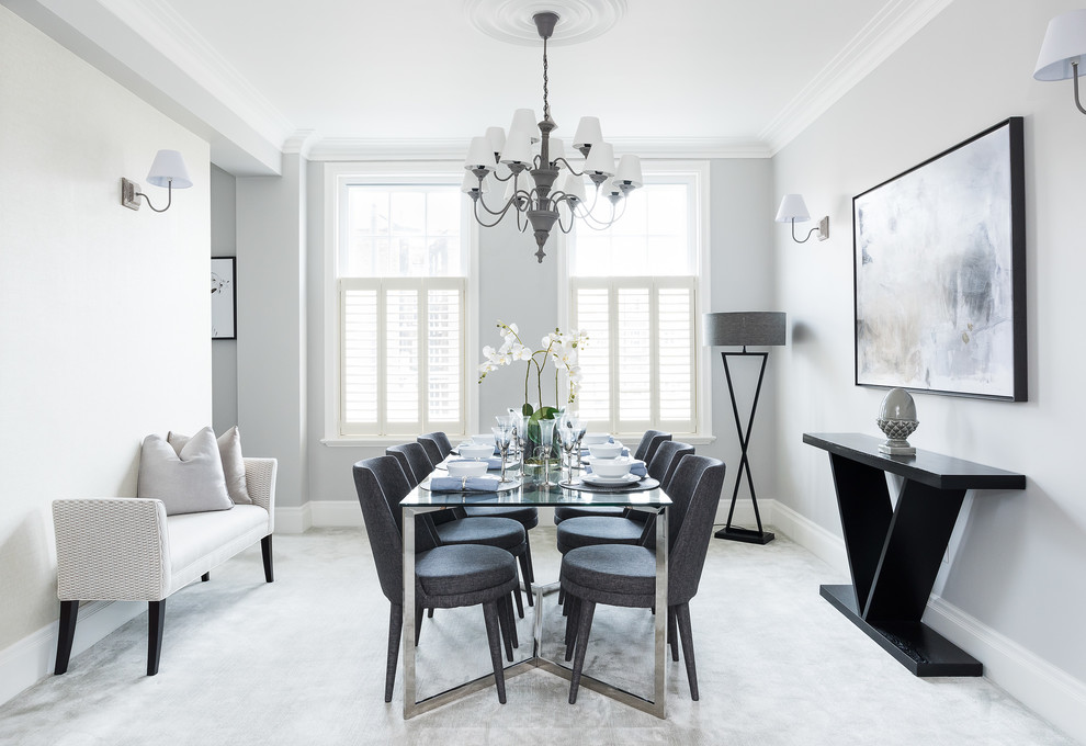 Photo of a traditional dining room in London with grey walls and grey floors.
