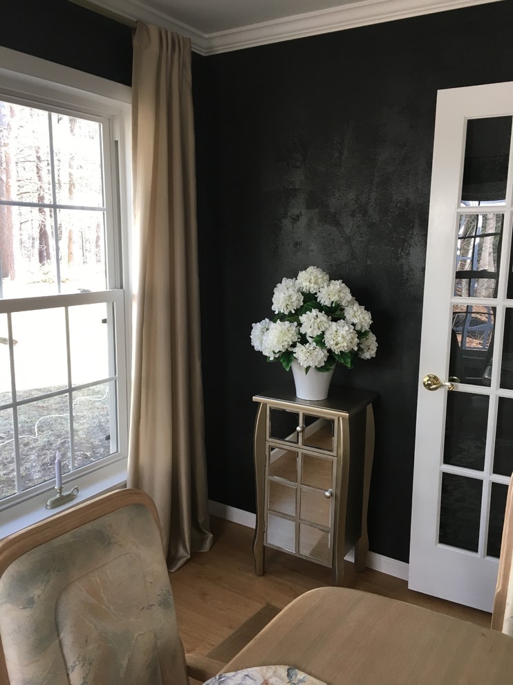 Inspiration for a modern dining room remodel in Boston with black walls