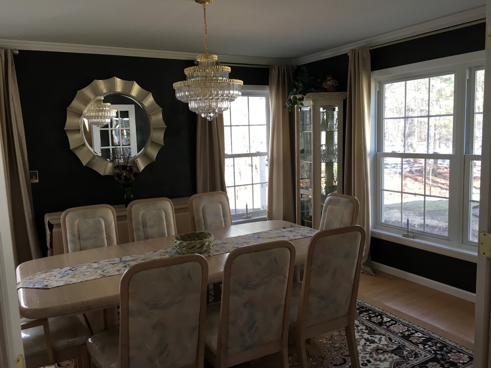 Mid-sized minimalist light wood floor enclosed dining room photo in Boston with black walls