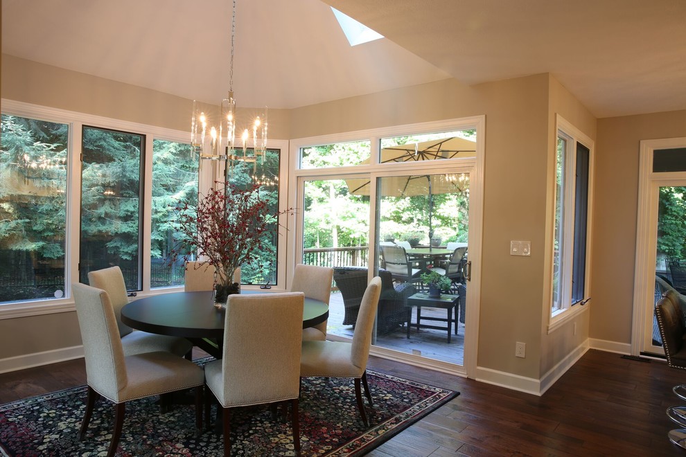 Inspiration for a mid-sized transitional dark wood floor and brown floor kitchen/dining room combo remodel in Indianapolis with beige walls, a corner fireplace and a stone fireplace