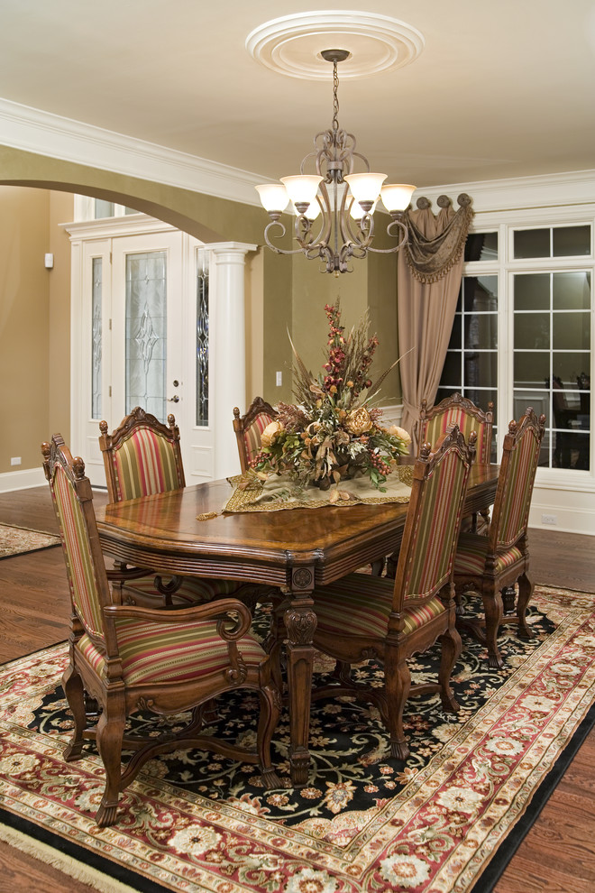 Elegant dining room photo in Chicago with green walls