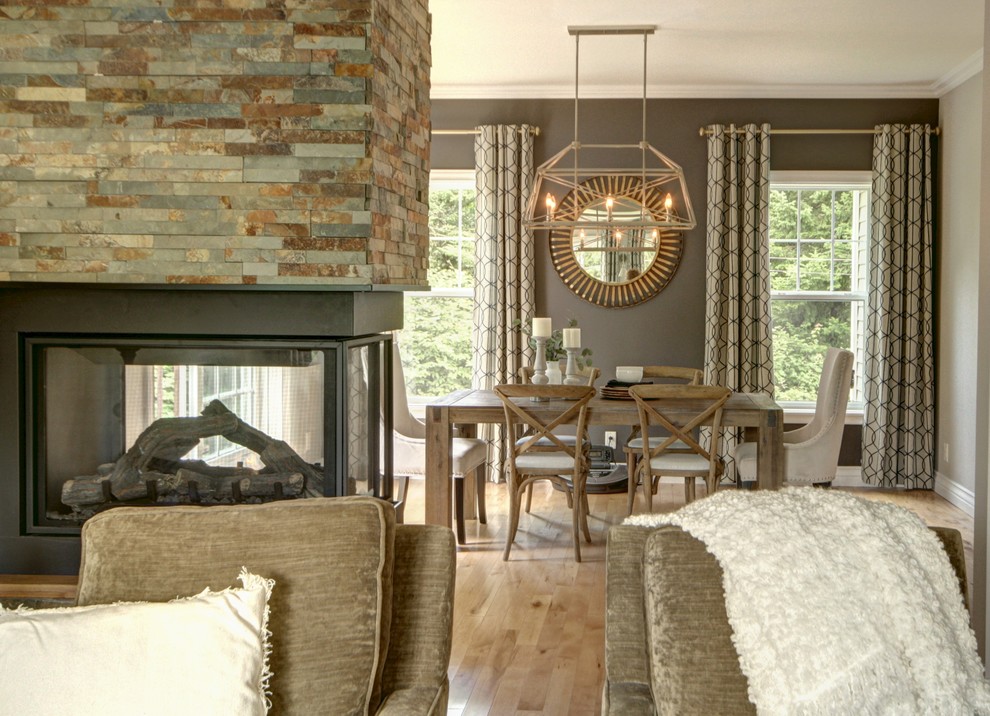 Mid-sized transitional light wood floor and brown floor enclosed dining room photo in Other with gray walls, a two-sided fireplace and a stone fireplace