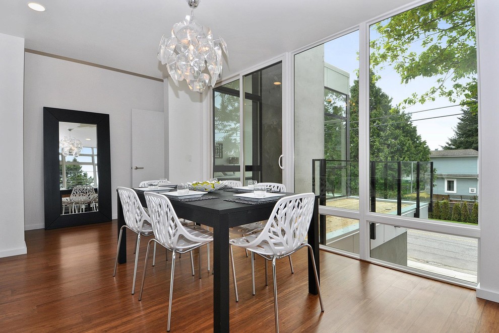 Example of a mid-sized minimalist dark wood floor enclosed dining room design in Seattle with white walls and no fireplace