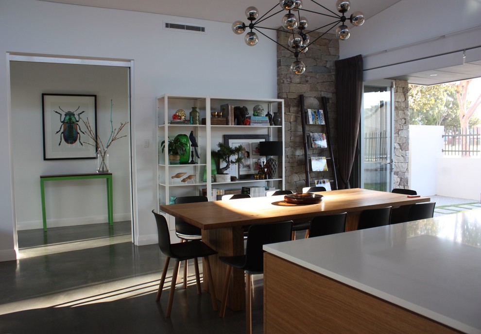 Design ideas for a modern dining room in Perth with white walls and concrete flooring.