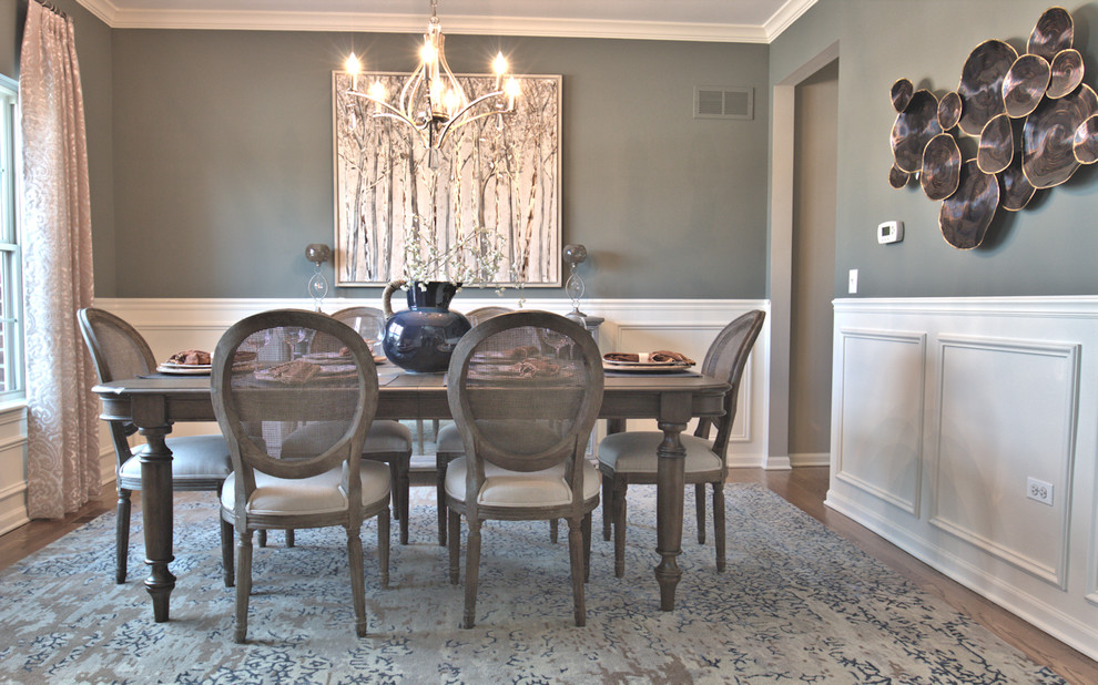 Small transitional medium tone wood floor enclosed dining room photo in Chicago with gray walls
