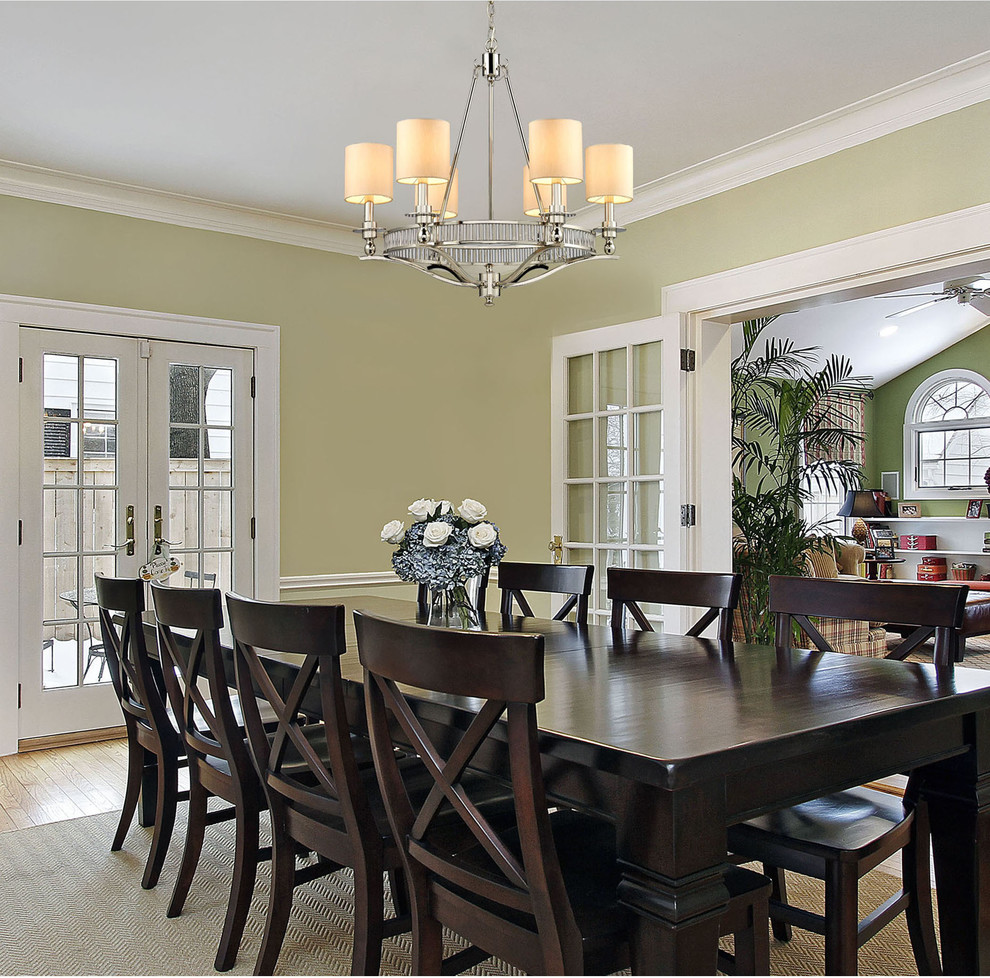Example of a mid-sized island style medium tone wood floor enclosed dining room design in New York with green walls and no fireplace