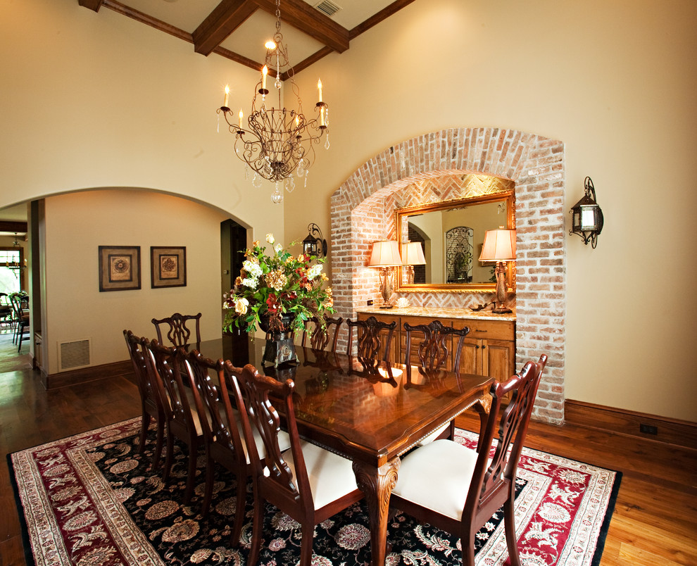 Large traditional enclosed dining room in New Orleans with beige walls, dark hardwood flooring, no fireplace and feature lighting.