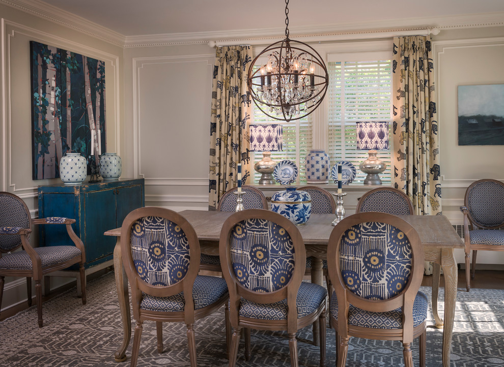 This is an example of a classic dining room in Providence with beige walls and medium hardwood flooring.
