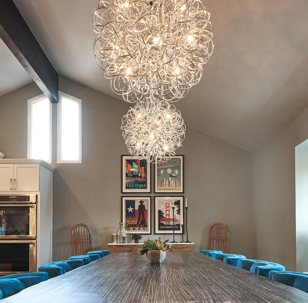 Inspiration pour une salle à manger ouverte sur le salon design de taille moyenne avec parquet foncé, un mur gris, une cheminée standard et un manteau de cheminée en brique.