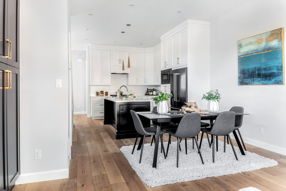 Transitional medium tone wood floor and brown floor kitchen/dining room combo photo in Vancouver with white walls and no fireplace