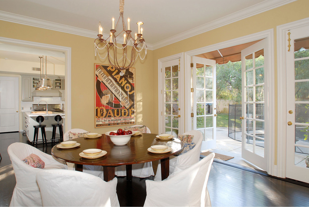 Inspiration for a traditional dining room in Los Angeles with yellow walls.