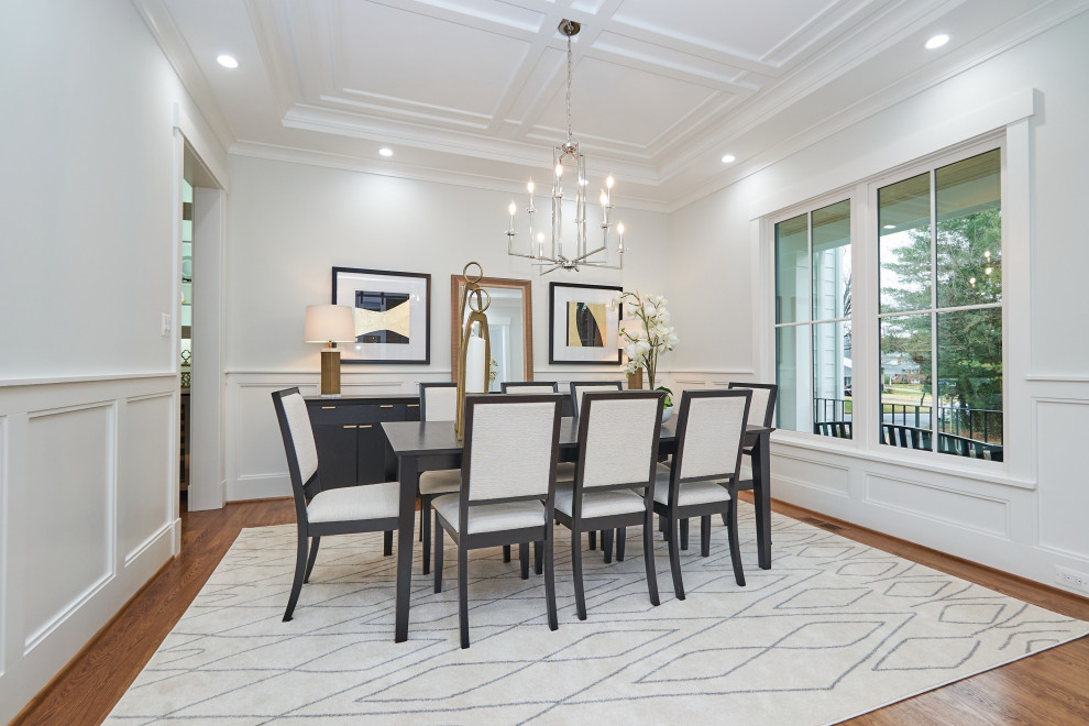 Inspiration for a large classic enclosed dining room in DC Metro with white walls, medium hardwood flooring, brown floors, no fireplace, a drop ceiling and panelled walls.