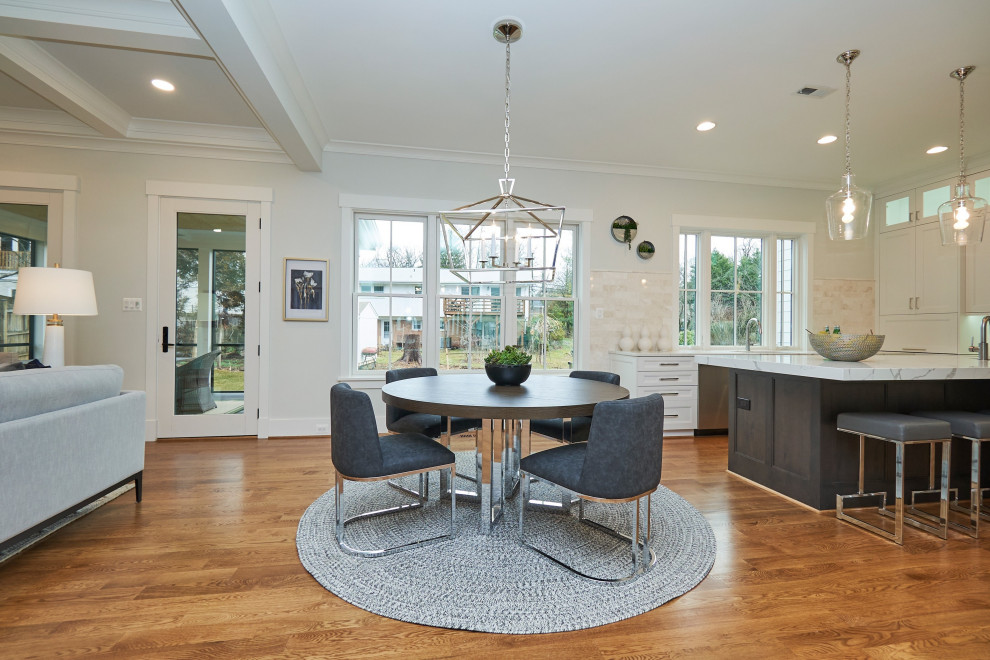 Photo of a large classic kitchen/dining room in DC Metro with white walls, medium hardwood flooring and brown floors.