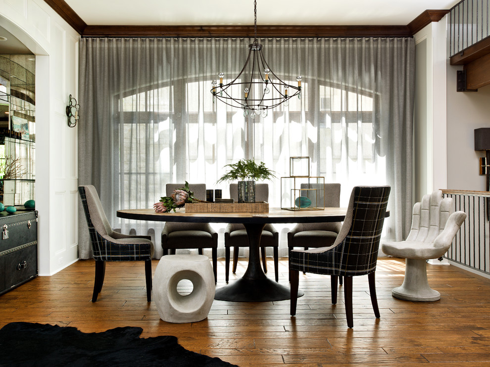 Contemporary dining room in Milwaukee with white walls and medium hardwood flooring.