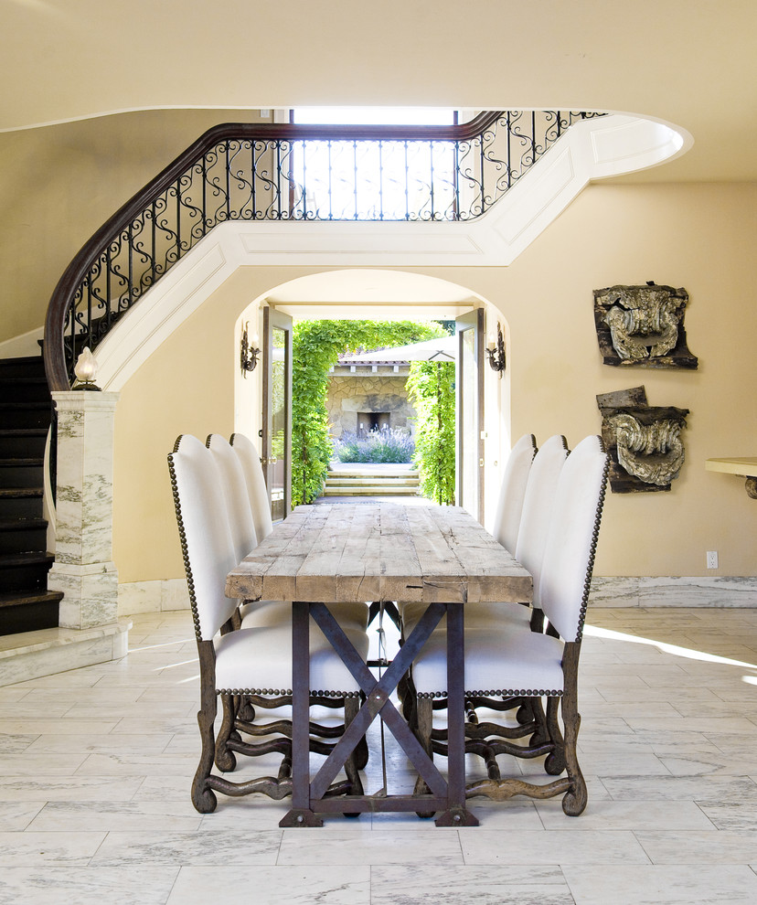 Dining room - mediterranean marble floor dining room idea in Santa Barbara with beige walls