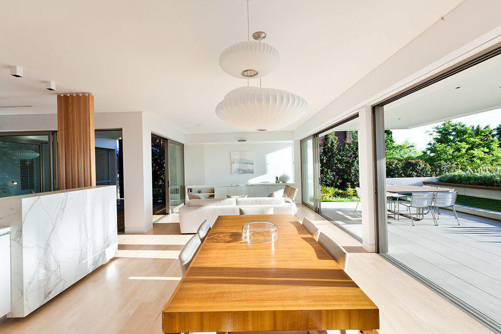 Photo of a contemporary dining room in Sydney with white walls.