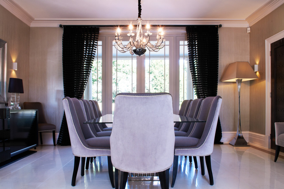 This is an example of a modern open plan dining room in Surrey with porcelain flooring and feature lighting.