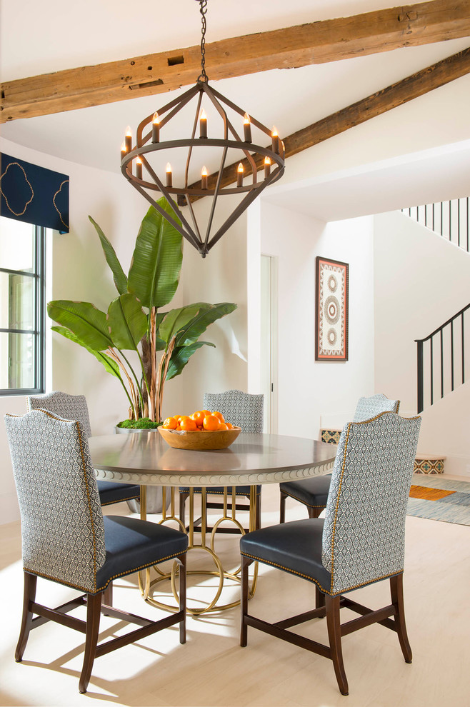 Photo of a mediterranean dining room in Dallas with white walls and beige floors.