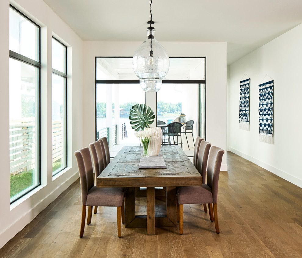 Beach style dining room in Other with white walls, medium hardwood flooring and no fireplace.