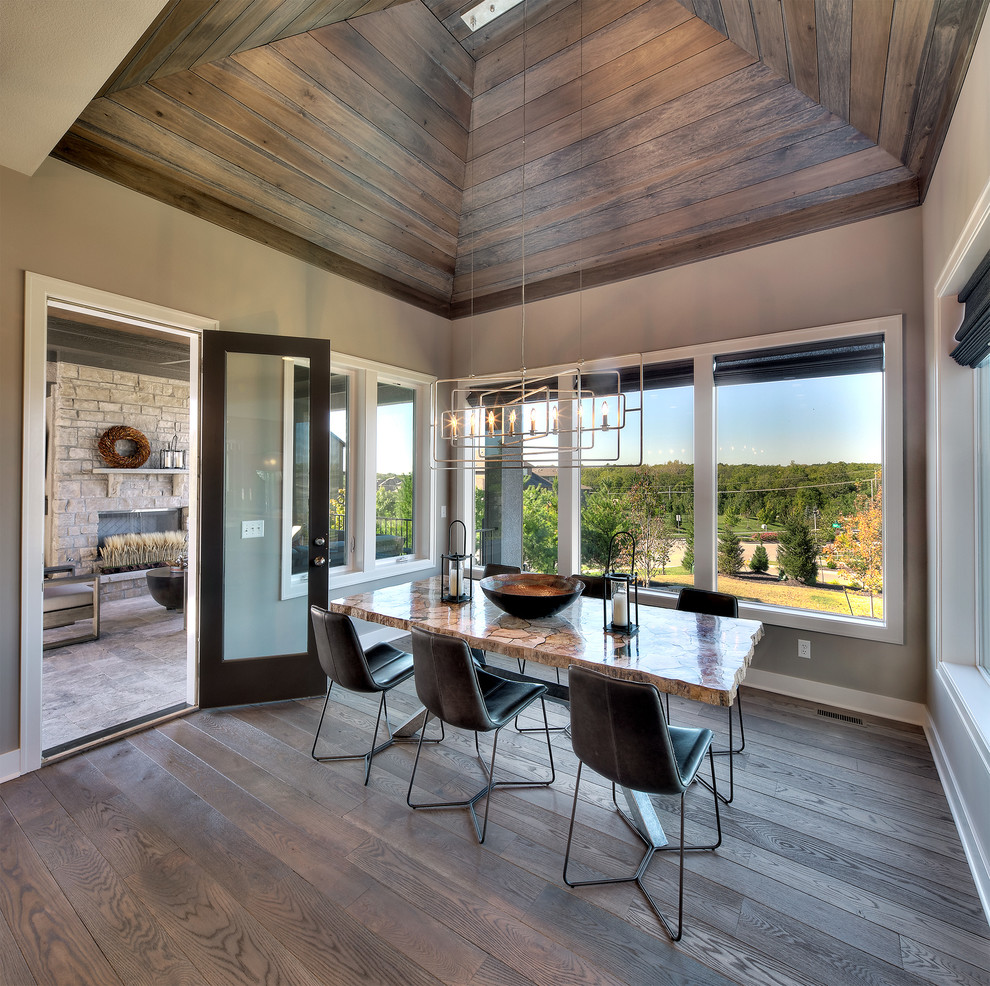 Inspiration for a transitional dark wood floor and brown floor enclosed dining room remodel in Kansas City with beige walls