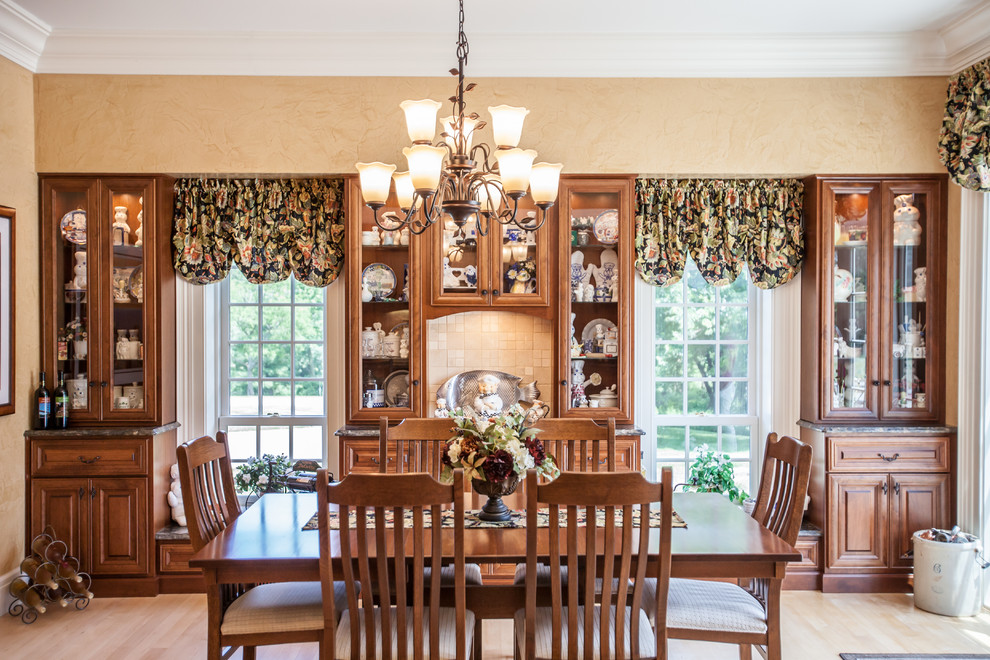 This is an example of a large traditional kitchen/dining room in Other with beige walls, light hardwood flooring and no fireplace.