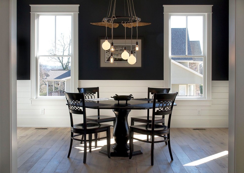 Mid-sized farmhouse light wood floor and brown floor enclosed dining room photo in Other with black walls and no fireplace